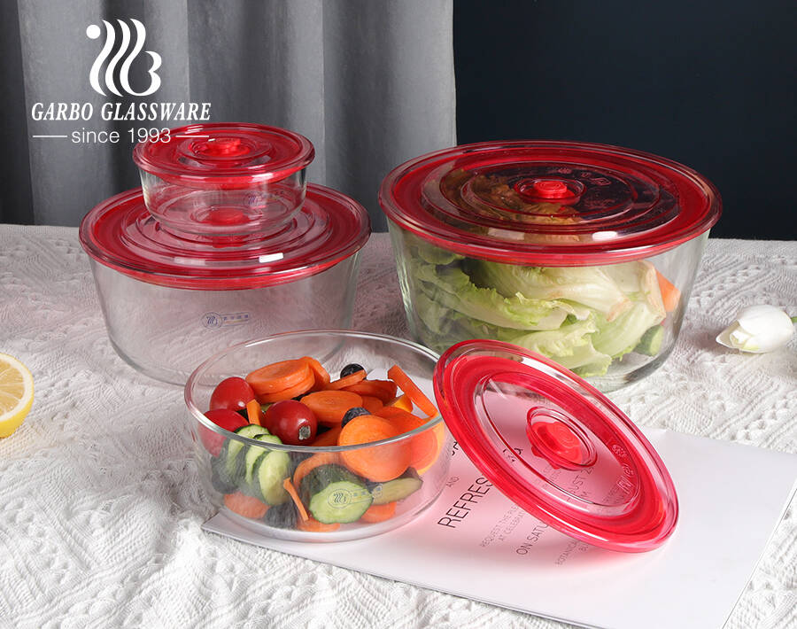 Contenedor de alimentos de vidrio redondo de alto borosilicato resistente al calor de fábrica con tapa de plástico sellada con orificio de aire