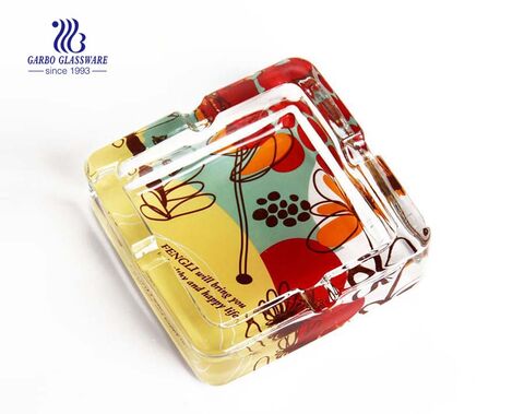 Clear glass ashtray with foundation and grooves for living room
