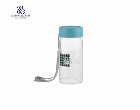 Daily use 260ml beverage clear glass drinking bottle with cover and string