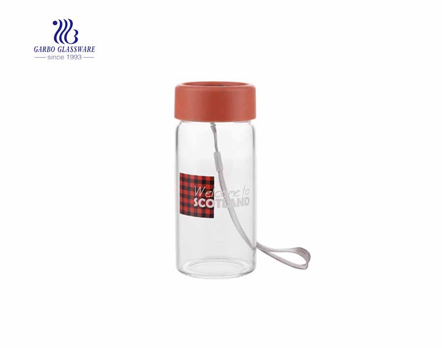 Daily use 260ml beverage clear glass drinking bottle with cover and string