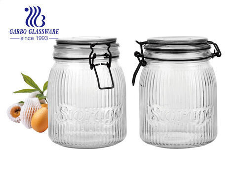 Wholesale cheap machine-made embossed round glass storage jar with engraved pattern with metal clip 