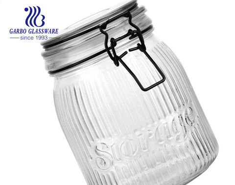 Wholesale cheap machine-made embossed round glass storage jar with engraved pattern with metal clip 