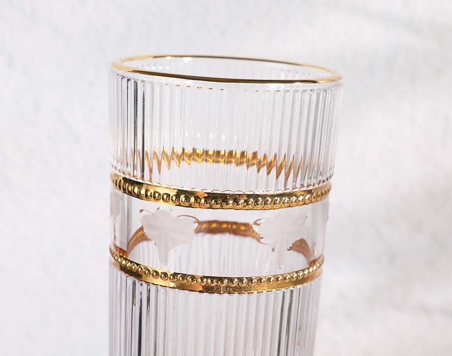 Unique high-end engraved glass cup with gold design in promotion