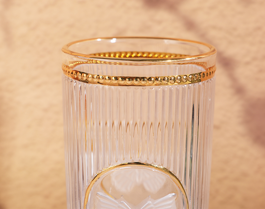 Unique high-end engraved glass cup with gold design in promotion