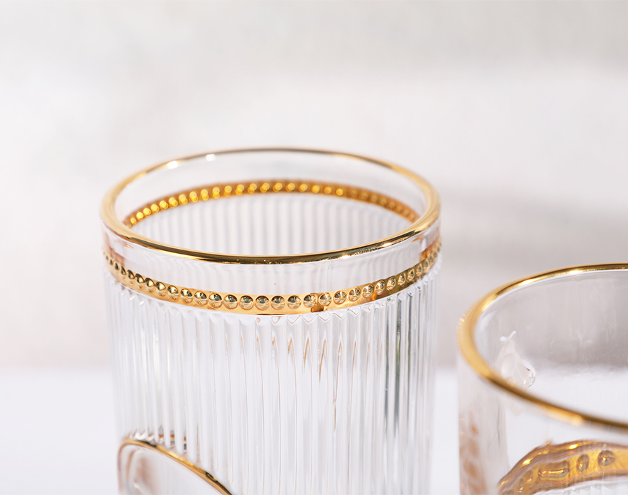 Unique high-end engraved glass cup with gold design in promotion